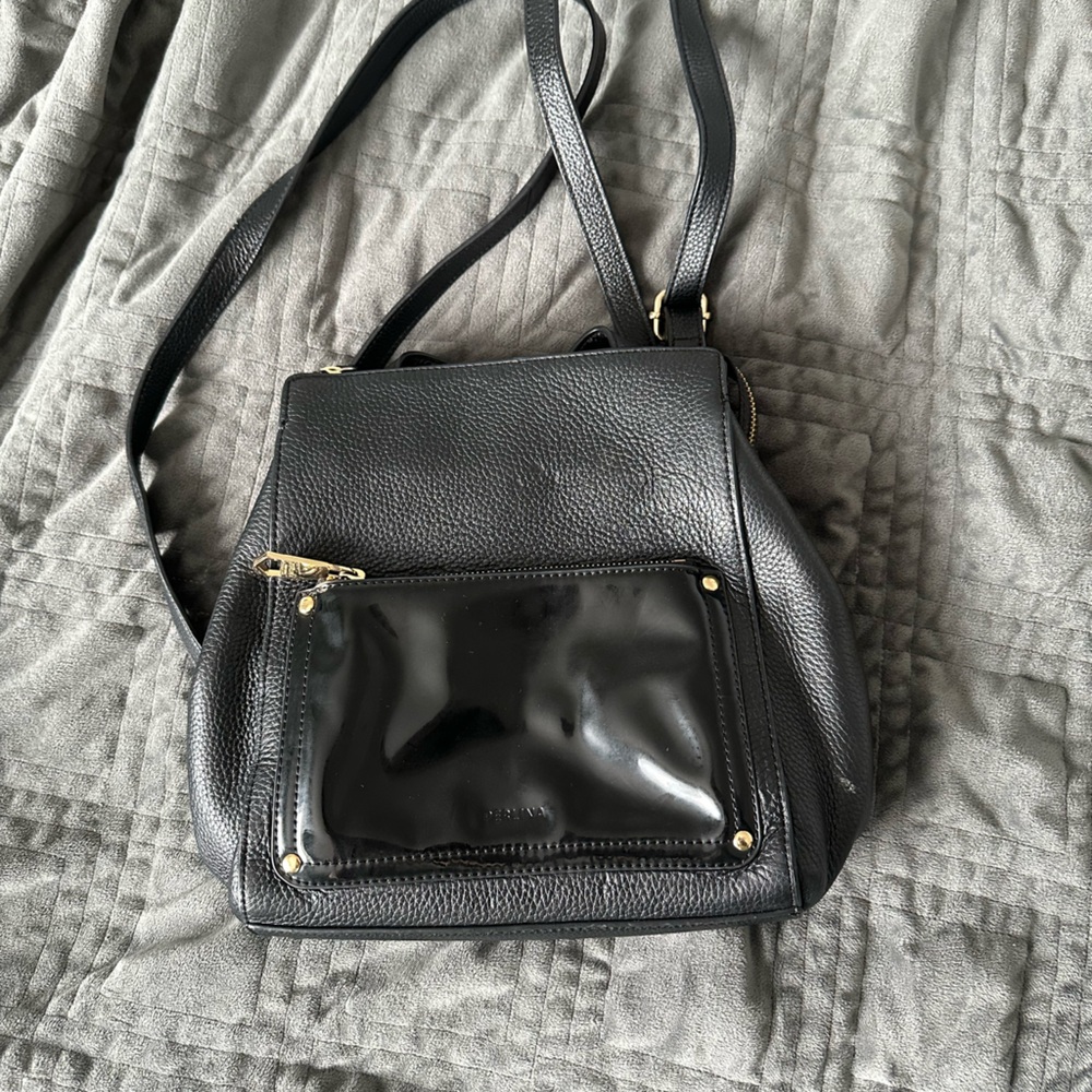 Sleek Black Perlina Convertible Leather Backpack with Gold Hardware
